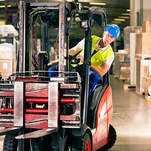 © kzenon istock gettyimages plus Arbeiter im Lager auf Staplerfahrer